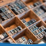 Closeup of metal printing letters in wooden compartments