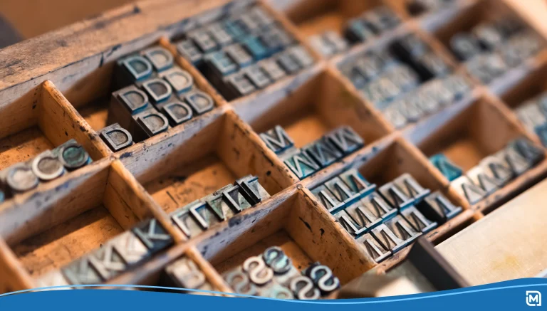 Closeup of metal printing letters in wooden compartments