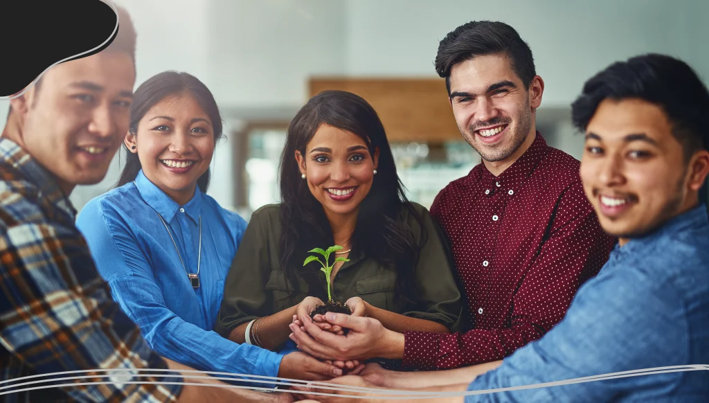 Group of people holding a plant