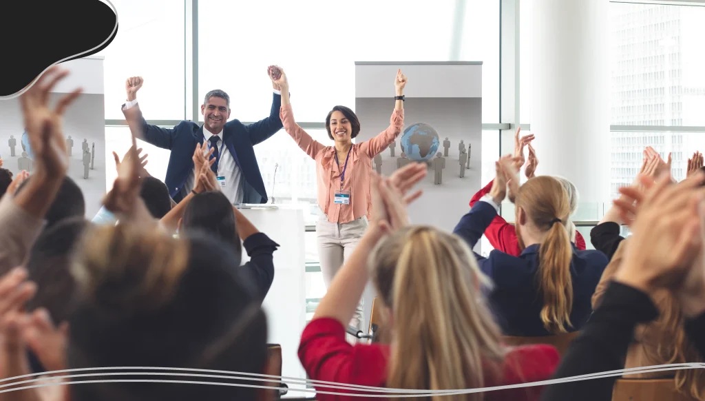 Diverse business people applauding at business seminar in office building