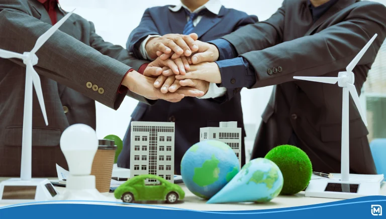 Three businessmen meet table to discuss corporate social responsibility